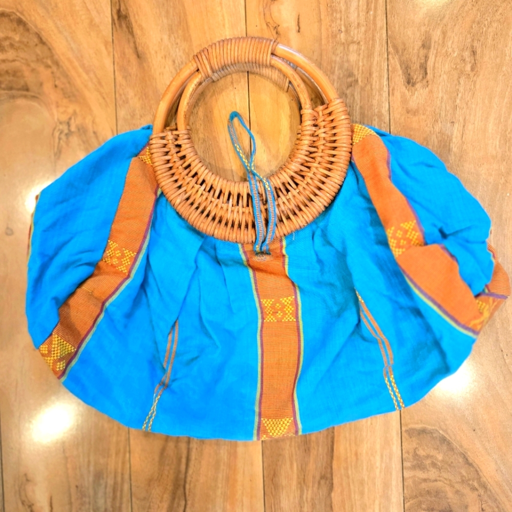 Aqua expandable bag. Wicker handles. Buttons at top. Beautiful fabric. Like new.
